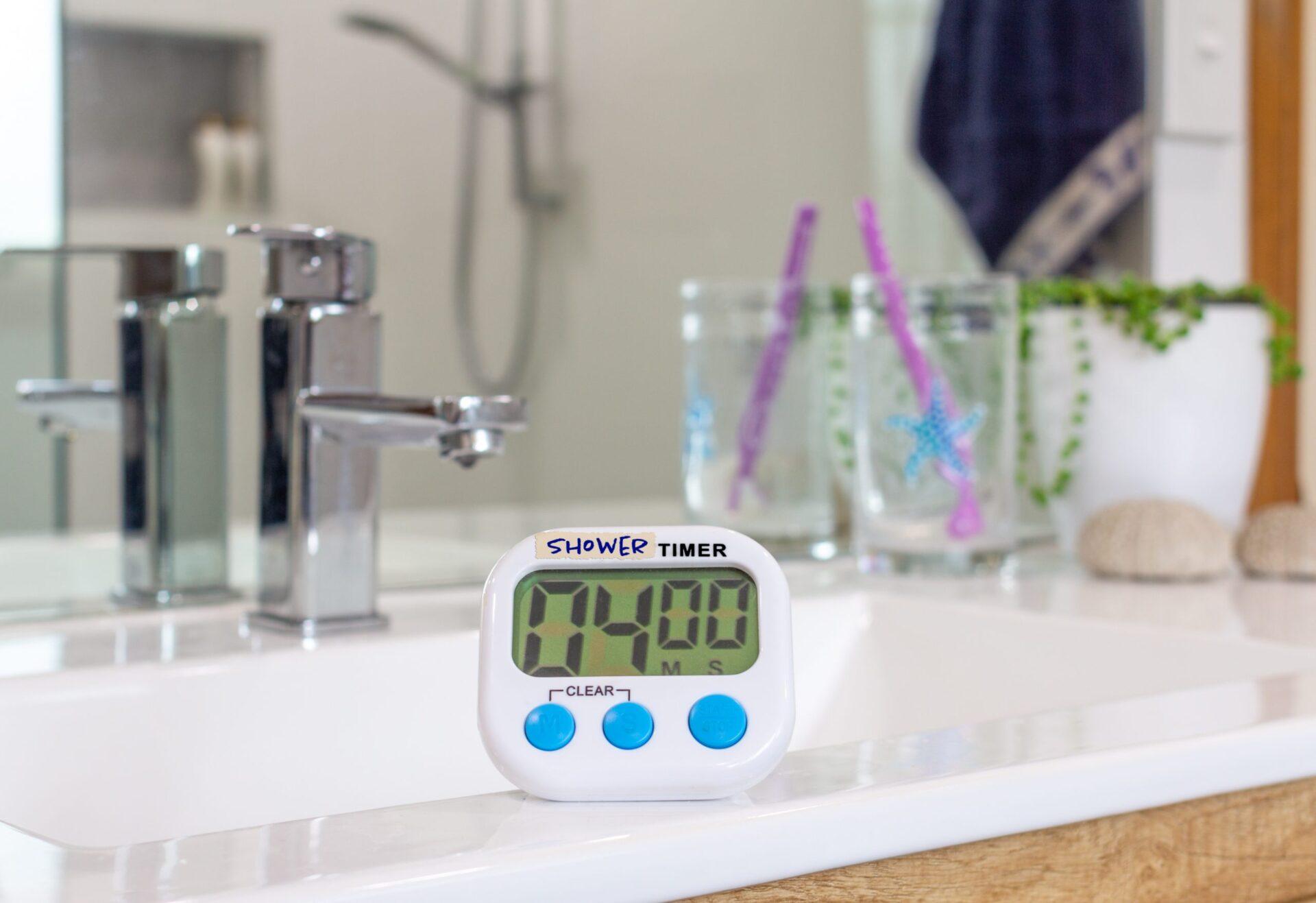 Shower timer in bathroom used to time showers to save money on water bill.